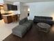 Living room and kitchen with breakfast bar seating and hardwood floors at 2704 Otter Creek Ct # 101, Las Vegas, NV 89117