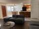 Open concept living space featuring a wood door and window views, with a kitchen and a gray sofa set at 2704 Otter Creek Ct # 101, Las Vegas, NV 89117