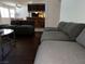 Open living area with gray sectional sofa leading to kitchen and breakfast bar at 2704 Otter Creek Ct # 101, Las Vegas, NV 89117