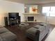 Cozy living room featuring a stone fireplace, dark wood flooring, and comfortable seating at 2704 Otter Creek Ct # 101, Las Vegas, NV 89117