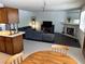 A spacious living room featuring a sectional couch, entertainment center, and cozy fireplace for relaxation at 2704 Otter Creek Ct # 101, Las Vegas, NV 89117