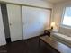 Living room with closet space, laminate floors, a comfortable sofa, and natural light from the window at 2704 Otter Creek Ct # 101, Las Vegas, NV 89117