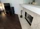 Living room with stone fireplace, dark floors, and entertainment center at 2704 Otter Creek Ct # 101, Las Vegas, NV 89117