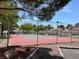 Community Tennis court surrounded by lush landscaping and nearby residences at 2704 Otter Creek Ct # 101, Las Vegas, NV 89117