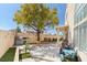 Backyard featuring hardscape patio, cooking area, mature shade tree, and privacy walls at 3367 Cheltenham St, Las Vegas, NV 89129