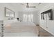 Bright bedroom featuring hardwood floors, a ceiling fan, and ample natural light at 3367 Cheltenham St, Las Vegas, NV 89129