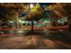 This nighttime view showcases the inviting community pool, illuminated by soft lighting and surrounded by mature trees at 3367 Cheltenham St, Las Vegas, NV 89129