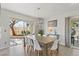 Bright dining room with modern table and chairs, complemented by natural light from sliding glass doors at 3367 Cheltenham St, Las Vegas, NV 89129