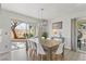 Bright dining room with modern lighting and sliding door access to outdoor patio at 3367 Cheltenham St, Las Vegas, NV 89129