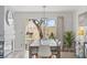 Bright dining room with modern table and chairs, complemented by natural light from sliding glass doors at 3367 Cheltenham St, Las Vegas, NV 89129
