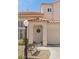 Inviting front entrance with a tiled roof and decorative wrought iron bench, adding a touch of charm at 3367 Cheltenham St, Las Vegas, NV 89129