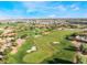 Aerial view of a lush golf course with sand traps and manicured greens under a bright blue sky at 3367 Cheltenham St, Las Vegas, NV 89129