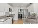 Modern kitchen featuring stainless steel appliances, gray countertops and wood-look flooring at 3367 Cheltenham St, Las Vegas, NV 89129