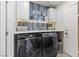 Organized laundry room with front-load washer and dryer, complemented by stylish decor for efficient laundry chores at 3367 Cheltenham St, Las Vegas, NV 89129