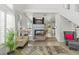 Open-concept living room showcasing a fireplace, staircase, and comfortable seating area, perfect for relaxation at 3367 Cheltenham St, Las Vegas, NV 89129