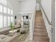 Bright living room featuring a staircase, fireplace, high ceilings, and many windows with shutters at 3367 Cheltenham St, Las Vegas, NV 89129