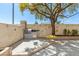 Backyard patio featuring an outdoor kitchen with grill and a whimsical swing hanging from a mature tree at 3367 Cheltenham St, Las Vegas, NV 89129