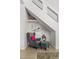 Cozy reading nook under the stairs with chair, ottoman and charming decor for a relaxing space at 3367 Cheltenham St, Las Vegas, NV 89129