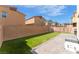 Spacious backyard has artificial turf, a patio, and block wall that offers privacy at 3815 Corellia Ave, North Las Vegas, NV 89084