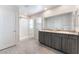 Modern bathroom featuring double sinks, granite countertops, and a tiled shower with glass enclosure at 3815 Corellia Ave, North Las Vegas, NV 89084