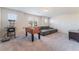 Spacious game room features carpet flooring, natural light and a comfortable sitting area at 3815 Corellia Ave, North Las Vegas, NV 89084