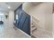 Inviting hallway featuring a decorative wall, tiled floors, and a carpeted staircase at 3815 Corellia Ave, North Las Vegas, NV 89084