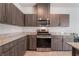 Well-equipped kitchen featuring a gas range, built-in microwave, and sleek wood cabinetry at 3815 Corellia Ave, North Las Vegas, NV 89084