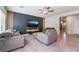 Open-concept living room with access to the hallway and featuring comfortable gray furniture at 3815 Corellia Ave, North Las Vegas, NV 89084