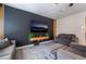 Modern living room with dark accent wall, decorative wood slats, and comfortable gray furniture at 3815 Corellia Ave, North Las Vegas, NV 89084