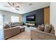 Comfortable living room with tile flooring, large TV on a decorative wall, and modern furniture at 3815 Corellia Ave, North Las Vegas, NV 89084