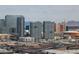 Expansive aerial view showcasing modern high-rise buildings and bustling city streets against a mountain backdrop at 4381 W Flamingo Rd # 3120, Las Vegas, NV 89103