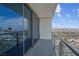 Balcony featuring panoramic city views through sleek glass railing and sliding glass doors at 4381 W Flamingo Rd # 3120, Las Vegas, NV 89103