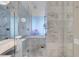 Bathroom showcasing marble tile, a glass enclosed shower and soaking tub, and modern chrome fixtures at 4381 W Flamingo Rd # 3120, Las Vegas, NV 89103