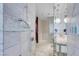 Sleek modern bathroom with marble tile, glass shower and bath, and stylish floating double vanity at 4381 W Flamingo Rd # 3120, Las Vegas, NV 89103