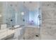 Bright bathroom with marble tile, glass shower enclosure, and modern fixtures at 4381 W Flamingo Rd # 3120, Las Vegas, NV 89103