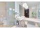 Bathroom featuring marble tile, vessel sinks, glass shower enclosure, and contemporary lighting at 4381 W Flamingo Rd # 3120, Las Vegas, NV 89103