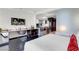Stylish room with desk, shelf, modern lighting, sleek floors, a kitchen area, and comfy bed with crisp white linens at 4381 W Flamingo Rd # 3120, Las Vegas, NV 89103