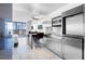 Sleek kitchen featuring stainless steel cabinets, island seating, and a view of the bedroom and balcony at 4381 W Flamingo Rd # 3120, Las Vegas, NV 89103