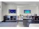 A modern living room featuring dark wood floors, wall mounted TV's, and a sleek desk and shelf combination at 4381 W Flamingo Rd # 3120, Las Vegas, NV 89103
