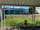 View of a spacious backyard with a covered patio and well-maintained lawn, perfect for outdoor entertaining at 4382 Valley Regal Way, North Las Vegas, NV 89032