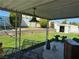 Inviting backyard featuring a covered patio, lush lawn, and storage shed, creating a serene outdoor space at 4382 Valley Regal Way, North Las Vegas, NV 89032