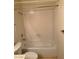 This white tiled bathroom features a combined tub and shower, toilet, and sink with vanity at 4382 Valley Regal Way, North Las Vegas, NV 89032
