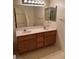 Double sink bathroom vanity with cabinet storage and a large mirror at 4382 Valley Regal Way, North Las Vegas, NV 89032