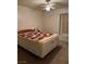 This bedroom features a cozy bed and a ceiling fan, providing comfort and functionality at 4382 Valley Regal Way, North Las Vegas, NV 89032