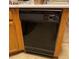 Close-up shot of a black dishwasher with light wood cabinetry at 4382 Valley Regal Way, North Las Vegas, NV 89032