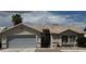 Charming single-story home with a well-manicured front yard and a two-car garage and neutral color scheme at 4382 Valley Regal Way, North Las Vegas, NV 89032