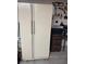 Full sized refrigerator in garage with additional storage at 4382 Valley Regal Way, North Las Vegas, NV 89032