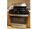 Close-up of a stainless steel and black gas range with four burners at 4382 Valley Regal Way, North Las Vegas, NV 89032