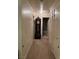 Hallway with neutral carpet, leading to a bathroom and bedroom at 4382 Valley Regal Way, North Las Vegas, NV 89032