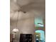 Vaulted ceiling kitchen with an overhead light fixture and upper display shelving at 4382 Valley Regal Way, North Las Vegas, NV 89032
